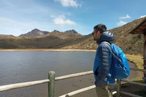 Tourist enjoying tranquil views of Limpiopungo Lake in Cotopaxi National Park