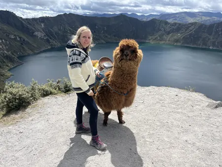 Tourist with an alpaca at Quilotoa Lagoon